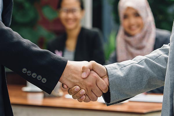 Shaking hands with Halal professionals.