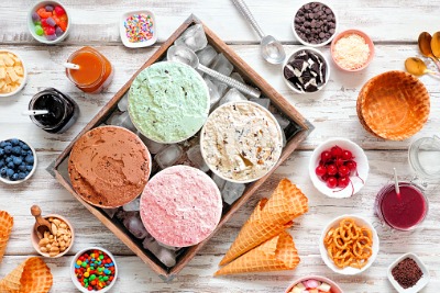 Summer ice cream buffet with a variety of ice cream flavors and sweet toppings.