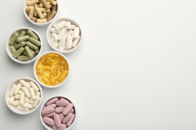 Different vitamin capsules in bowls.