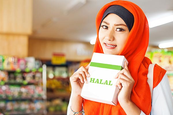 A woman holding a box labeled "Halal"