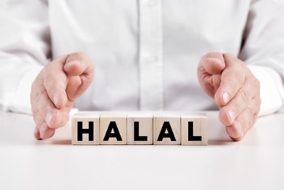 Businessman holding Halal sign.