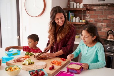 Children helping mother preparing lunches.