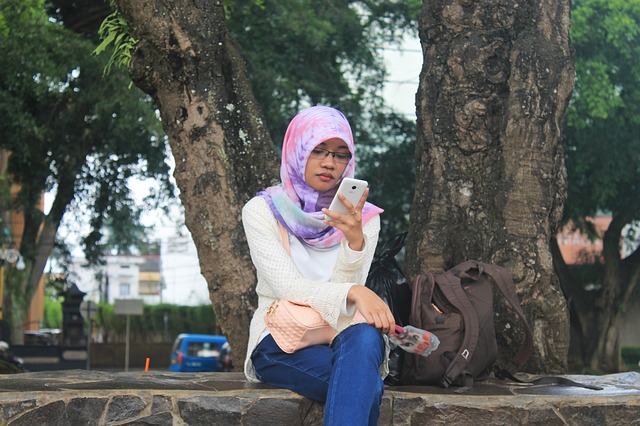 A young Muslim girl looking at her cellphone.jpg