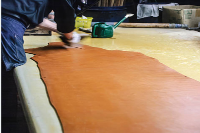 Processing leather with chemicals and colors.
