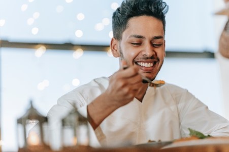 Muslim man eating Halal food.