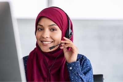 Muslim woman wearing hijab in a call center.