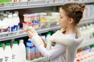 A little girl grocery shopping in the supermarket.