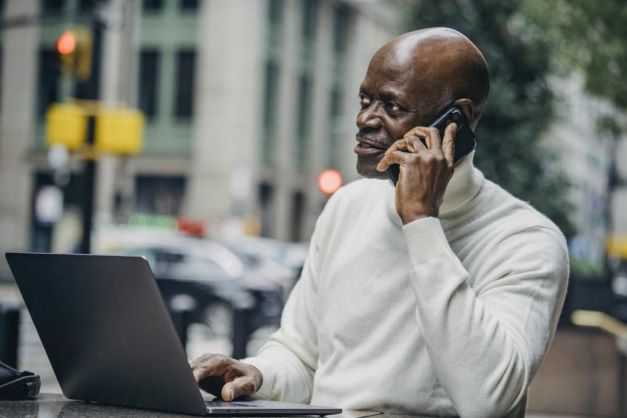 A man negotiating Halal business deals over the phone.