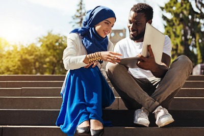 A Muslim man helping his wife.