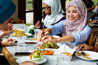 Muslim women eating Halal food together.