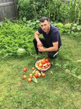 ISA employee Arben with garden vegetables