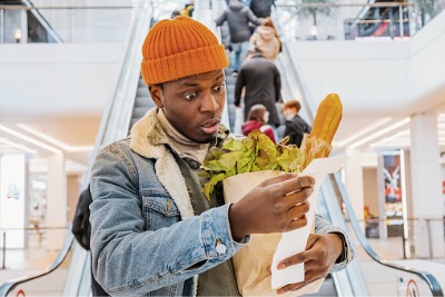 African man surprised at higher price of his groceries.