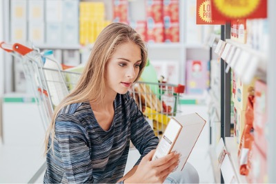 Woman reading food labels.