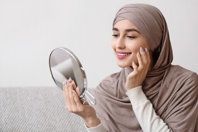 Muslim woman taking care of her skin.