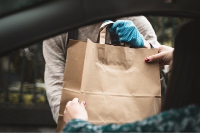 Woman received Halal food with take away bag.