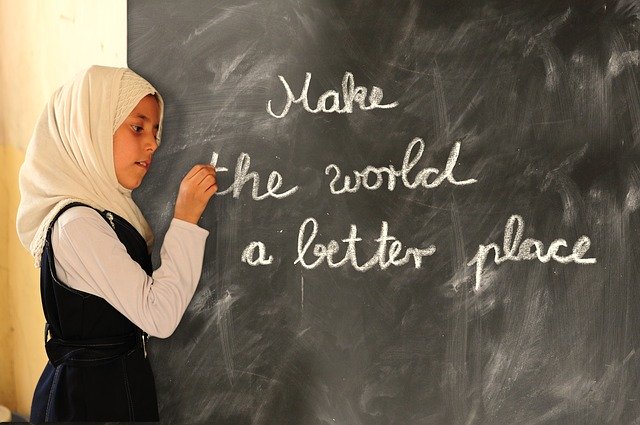 Muslim student writing on the blackboard.