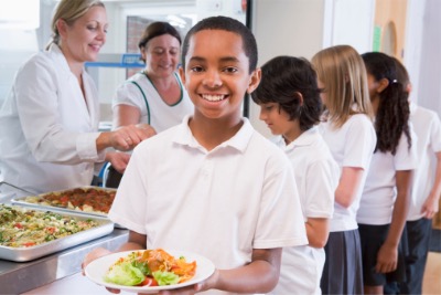 School boy carrying Halal lunch.