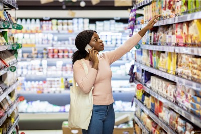 Black woman in the grocery isle making purchase decisions.