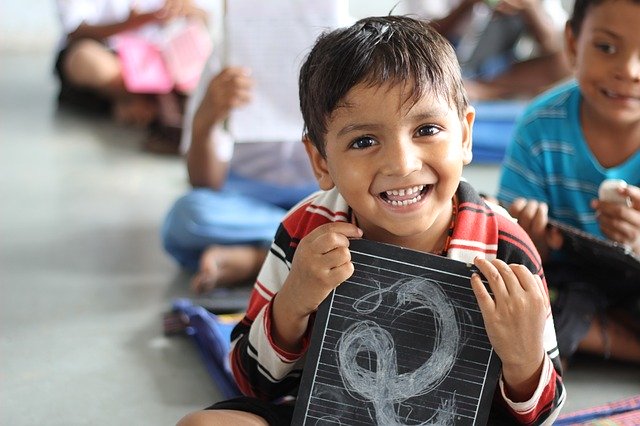 A little boy in his classroom.