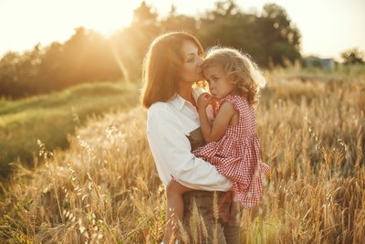 Woman carrying her daughter.