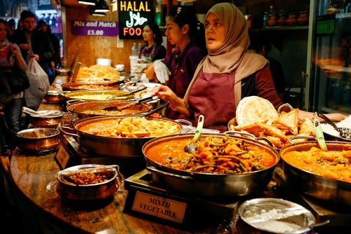 Muslim woman selling Halal food in a market.