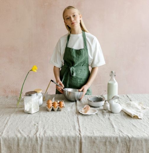 A lady making Halal cake with basic Halal ingredients.