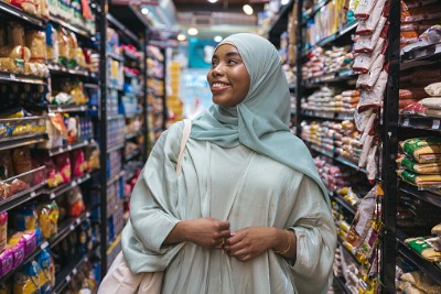 Muslim woman shopping in Halal grocery store.