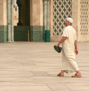 A Muslim man going to the mosque.